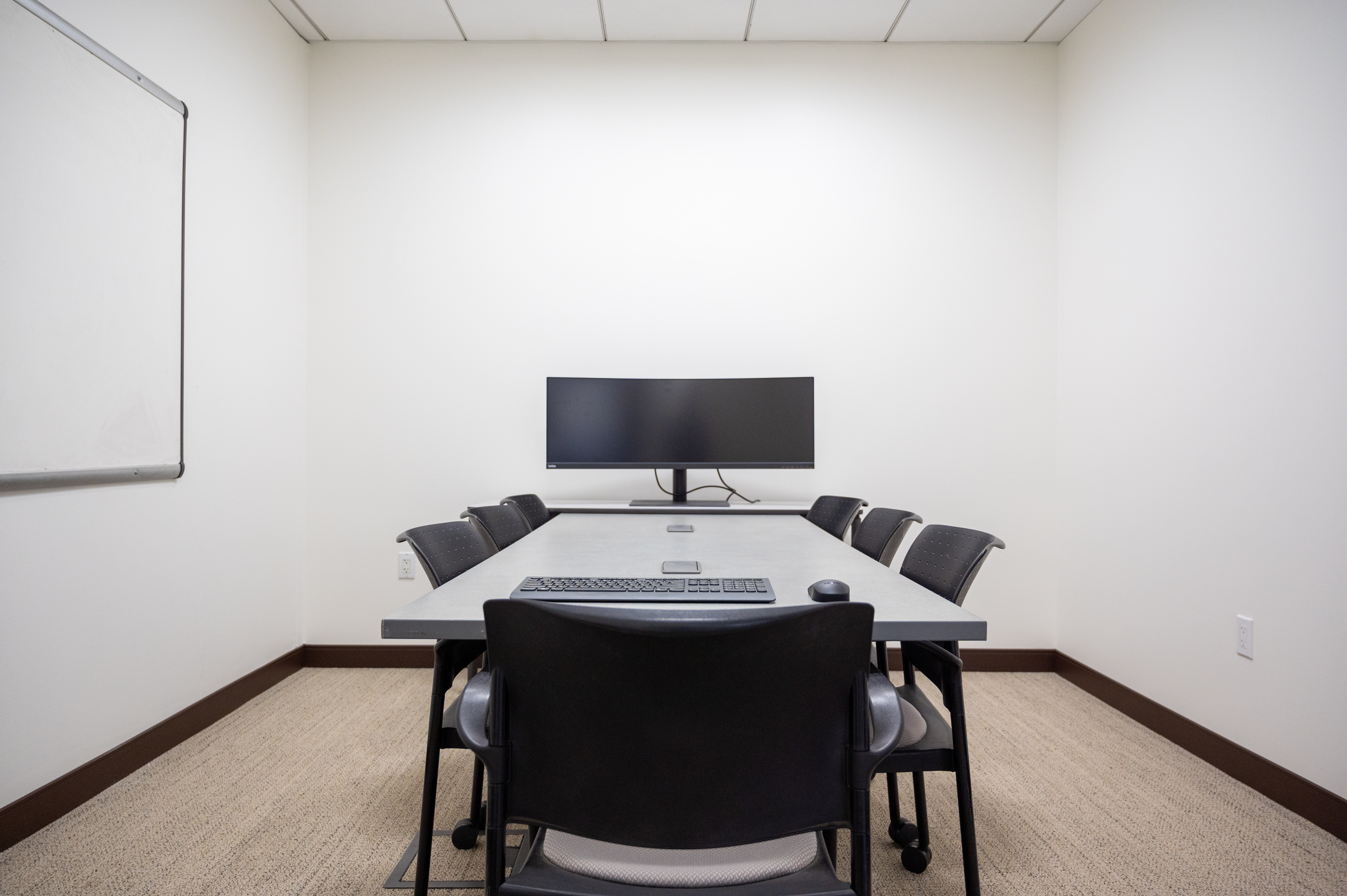 The Sequoia Room, which includes a meeting table that seats 7 people, a large computer monitor, and whiteboard.